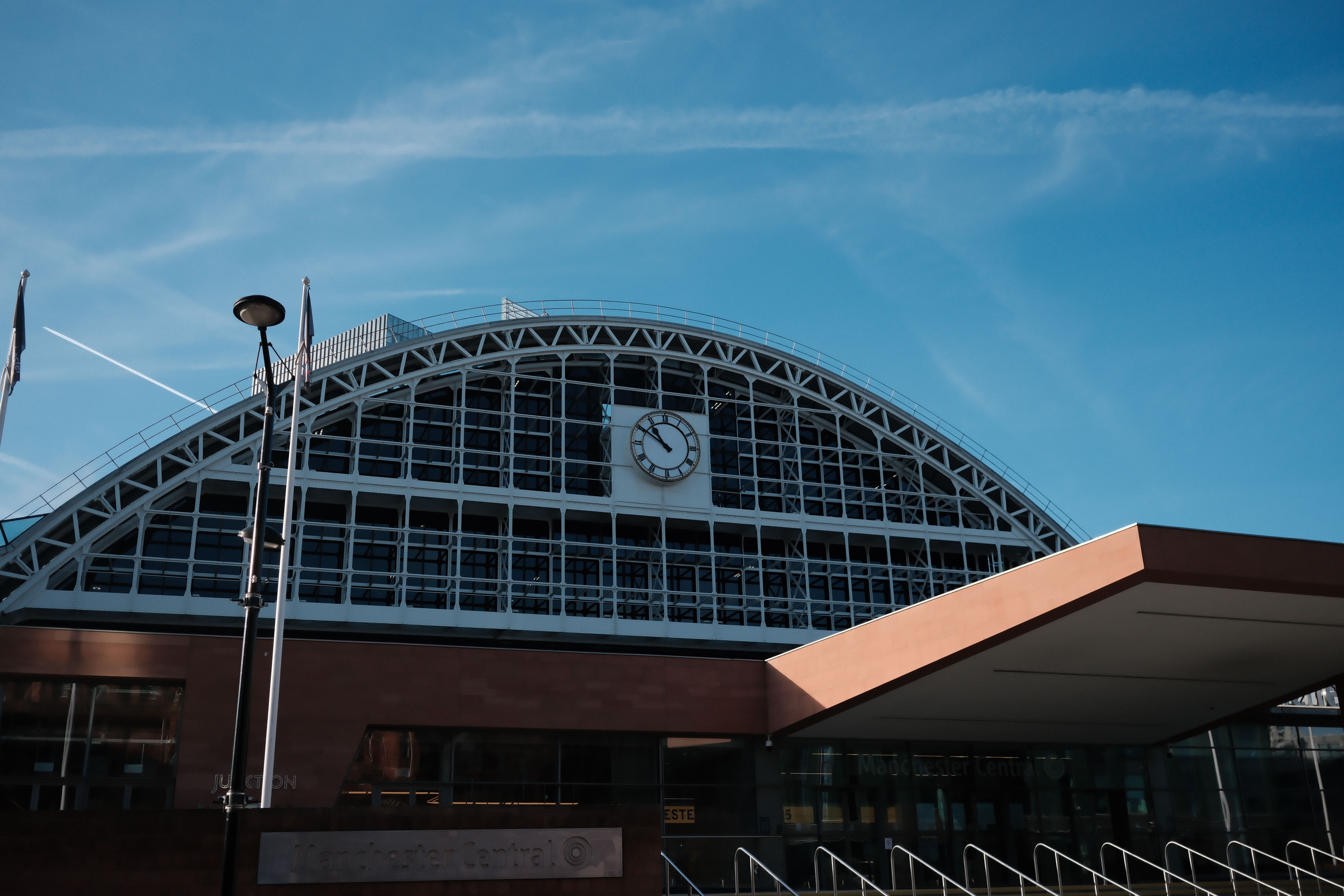 A sunny view of Manchester Central Convention Complex with blue sky and clock tower.
