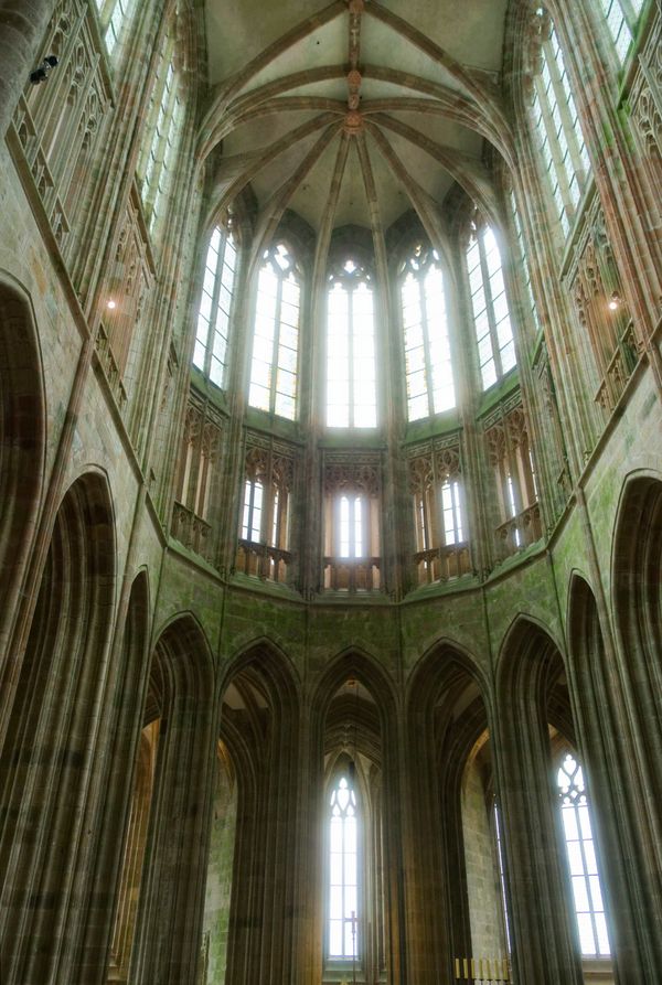 Elegant Gothic architecture of Abbey Le Mont-Saint-Michel with soaring arches and beautiful stained glass windows