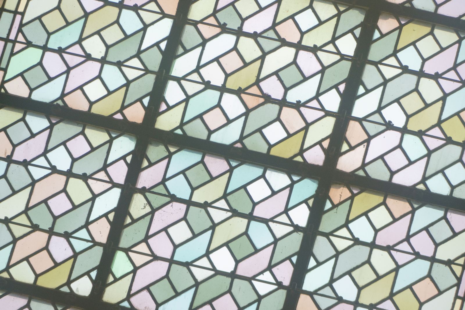 Pastel geometric stained glass window with a lead grid