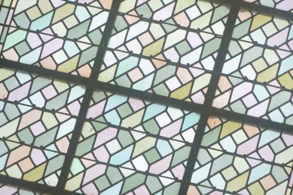 Pastel geometric stained glass window with a lead grid