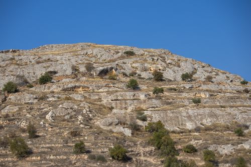 Free A rocky hillside landscape in Halfeti, Şanlıurfa, Türkiye with clear blue skies and sparse vegetation. Stock Photo