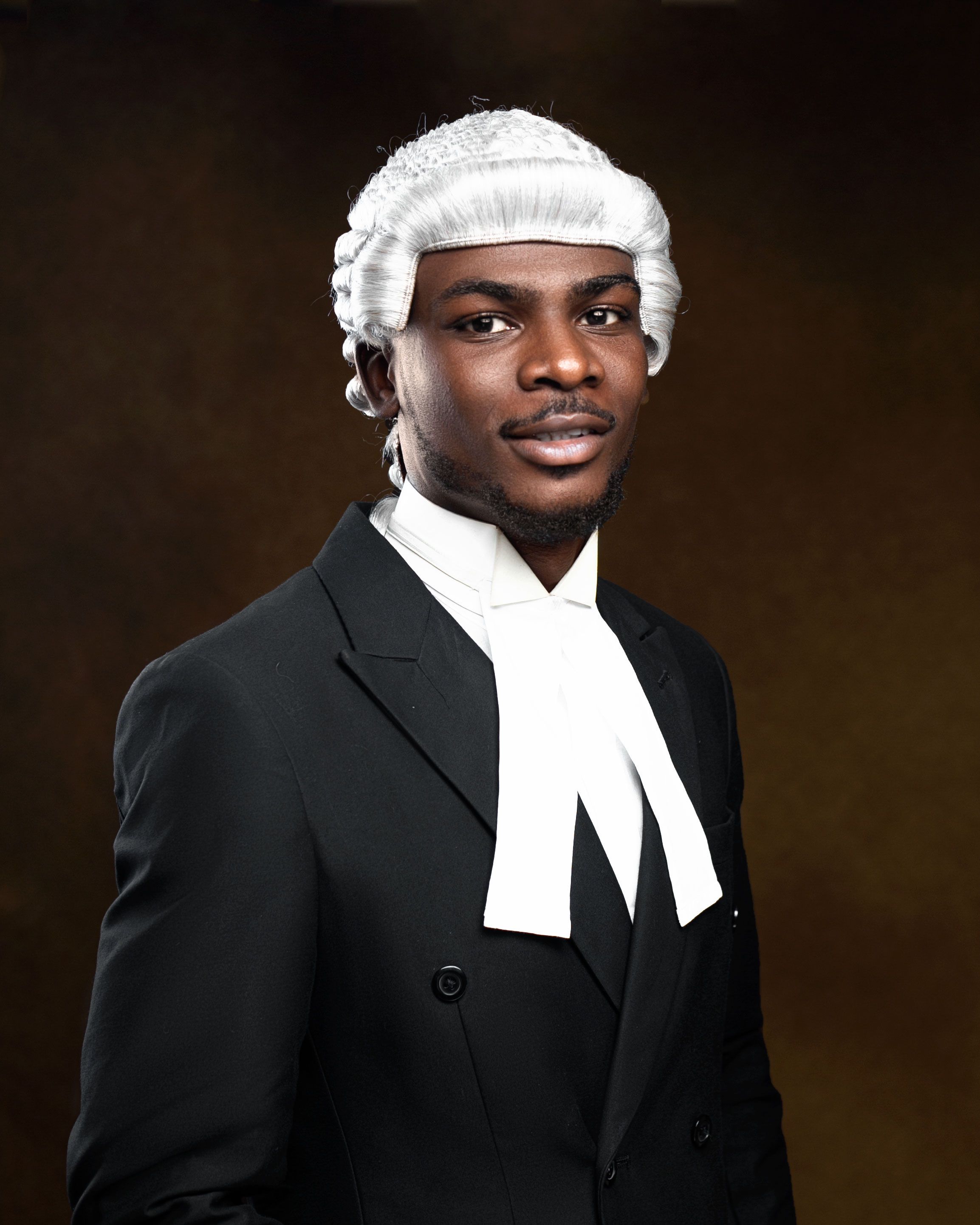 Elegant portrait of an African lawyer wearing traditional white wig and black robe.