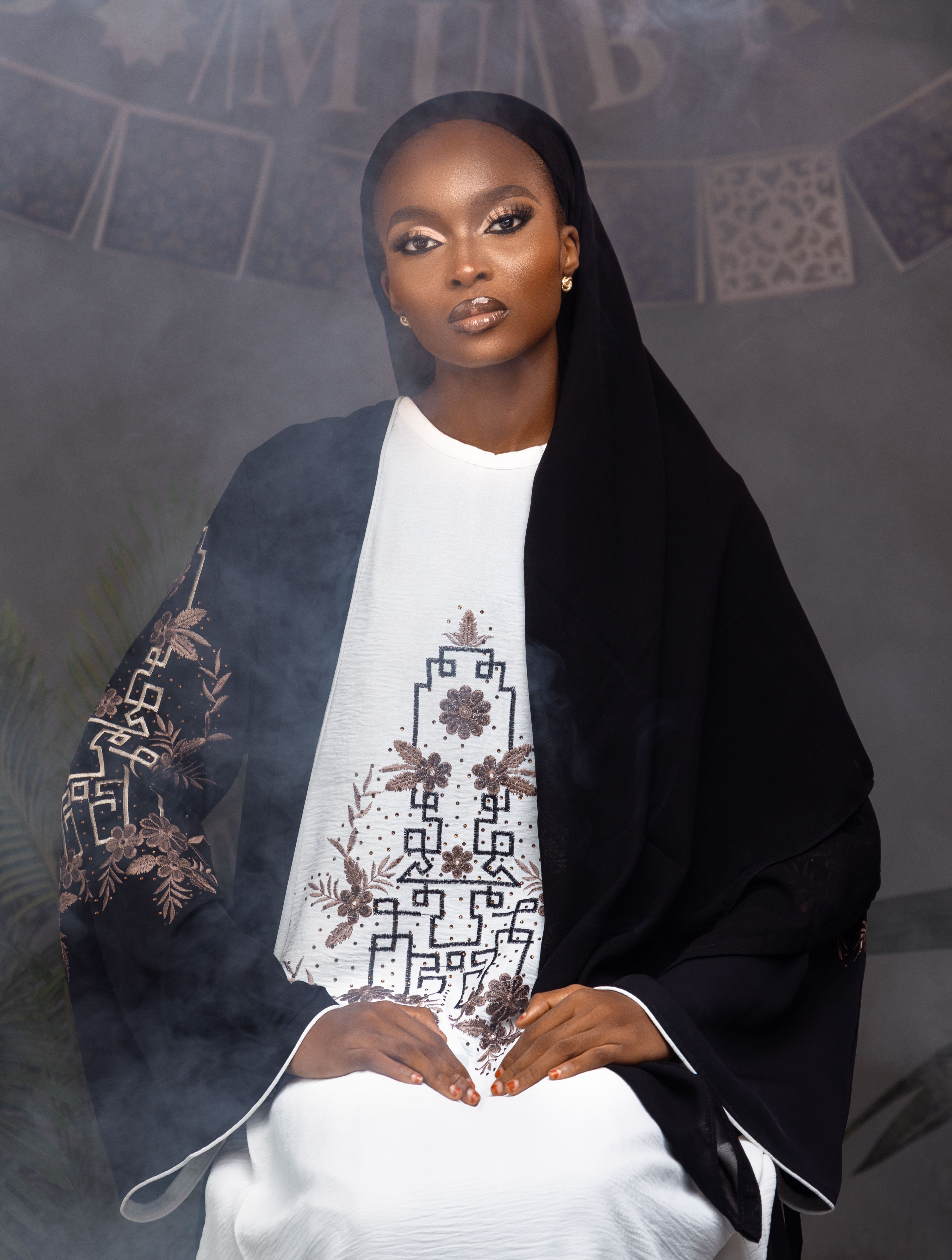 Sophisticated woman in traditional attire with intricate embroidery, creating an elegant and cultural ambiance.