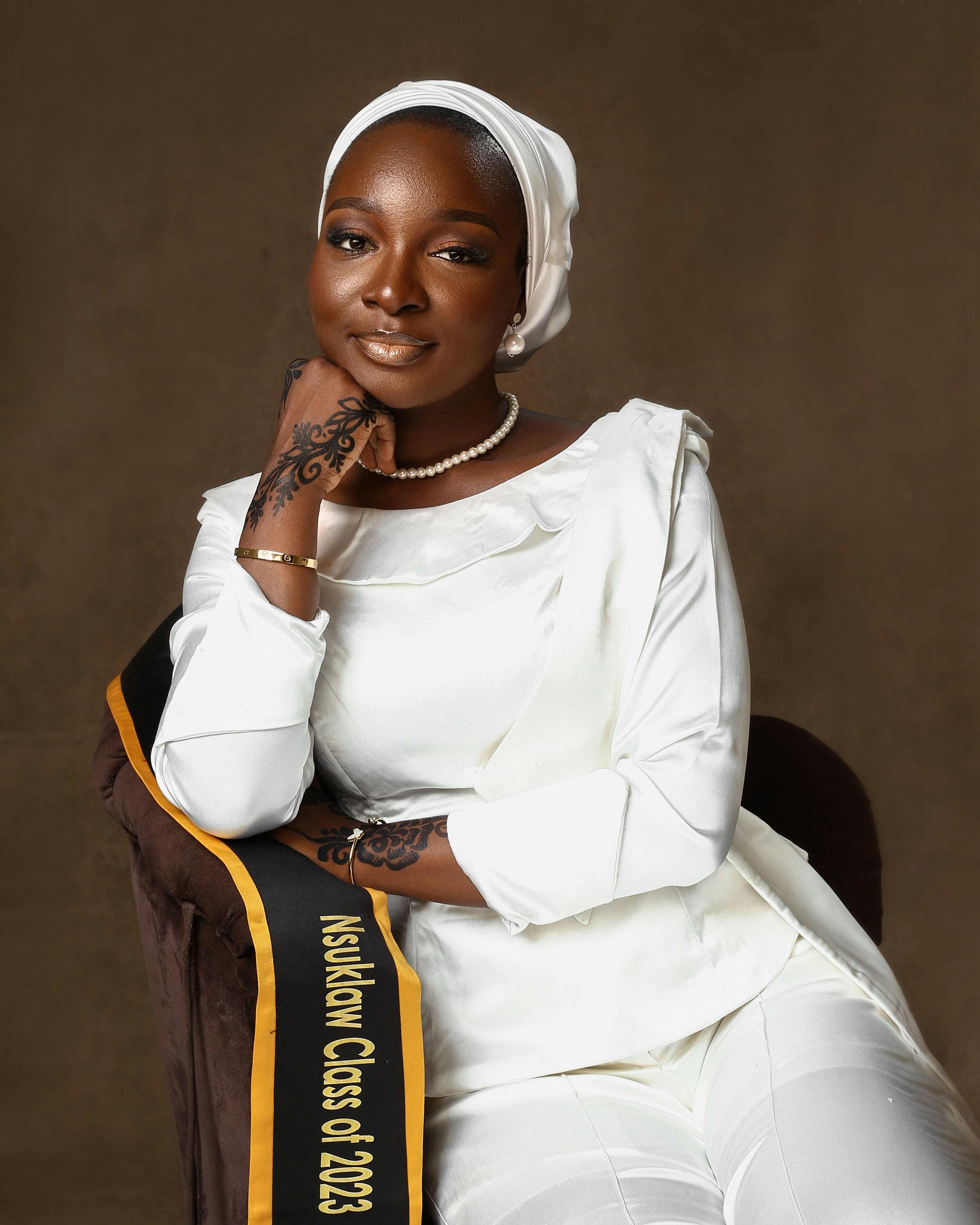 Free Stylish portrait of an African woman in graduation attire with a sash, 2023. Stock Photo