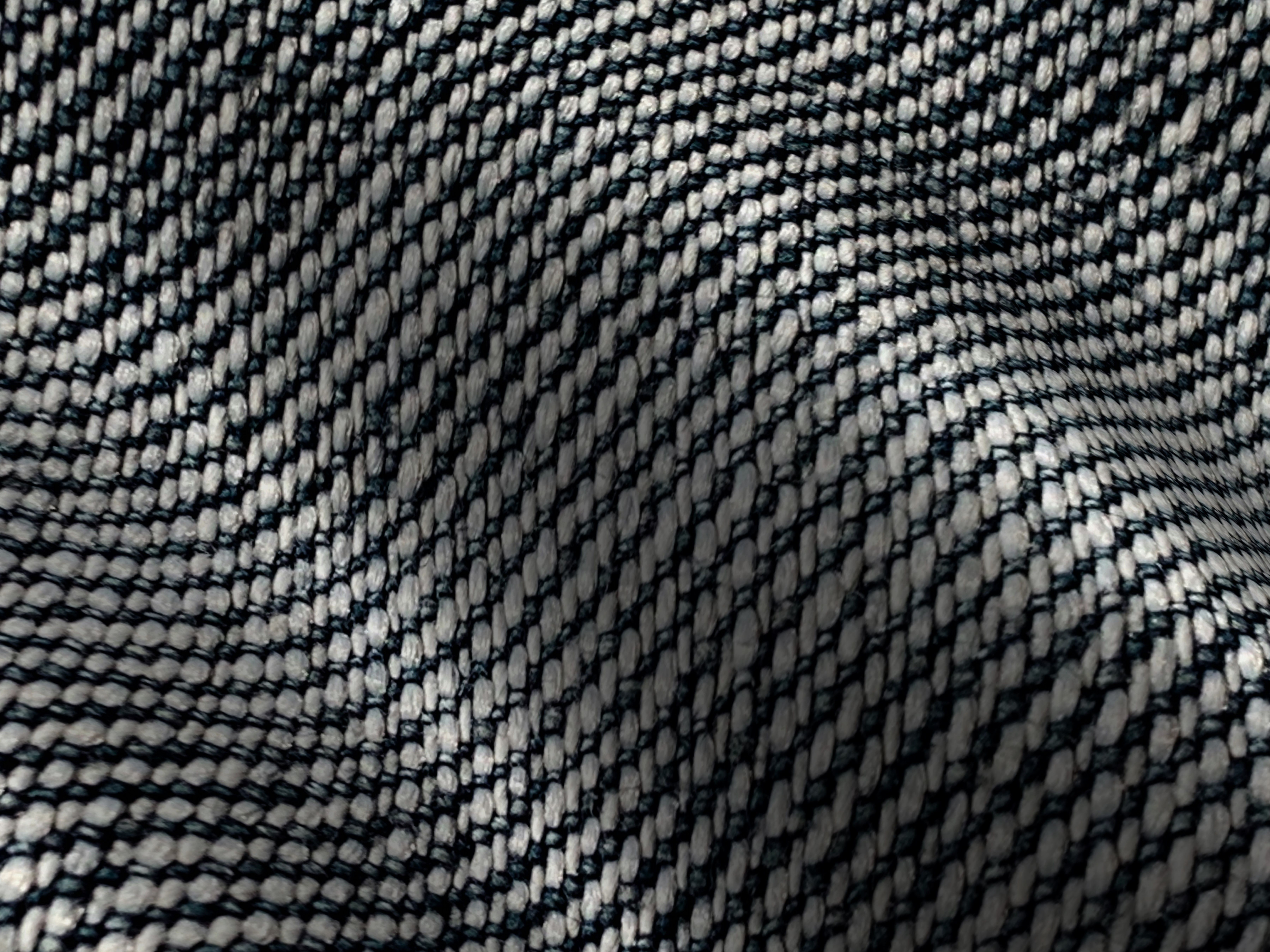 Detailed close-up of a woven textile fabric showcasing its intricate pattern and texture. — Maynard Longarm Quilting