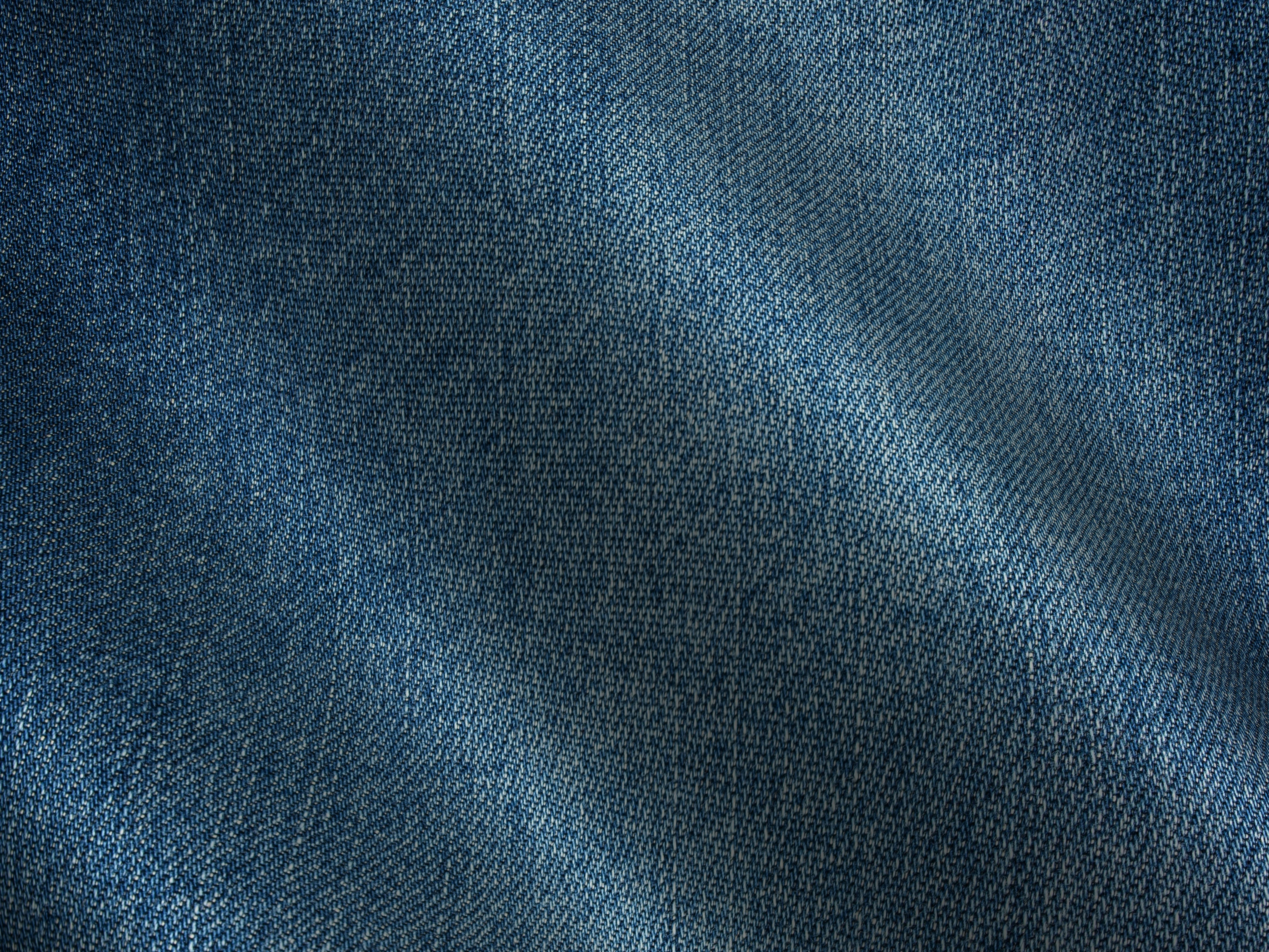 Free Detailed image of blue denim fabric showing texture and weave pattern. Stock Photo