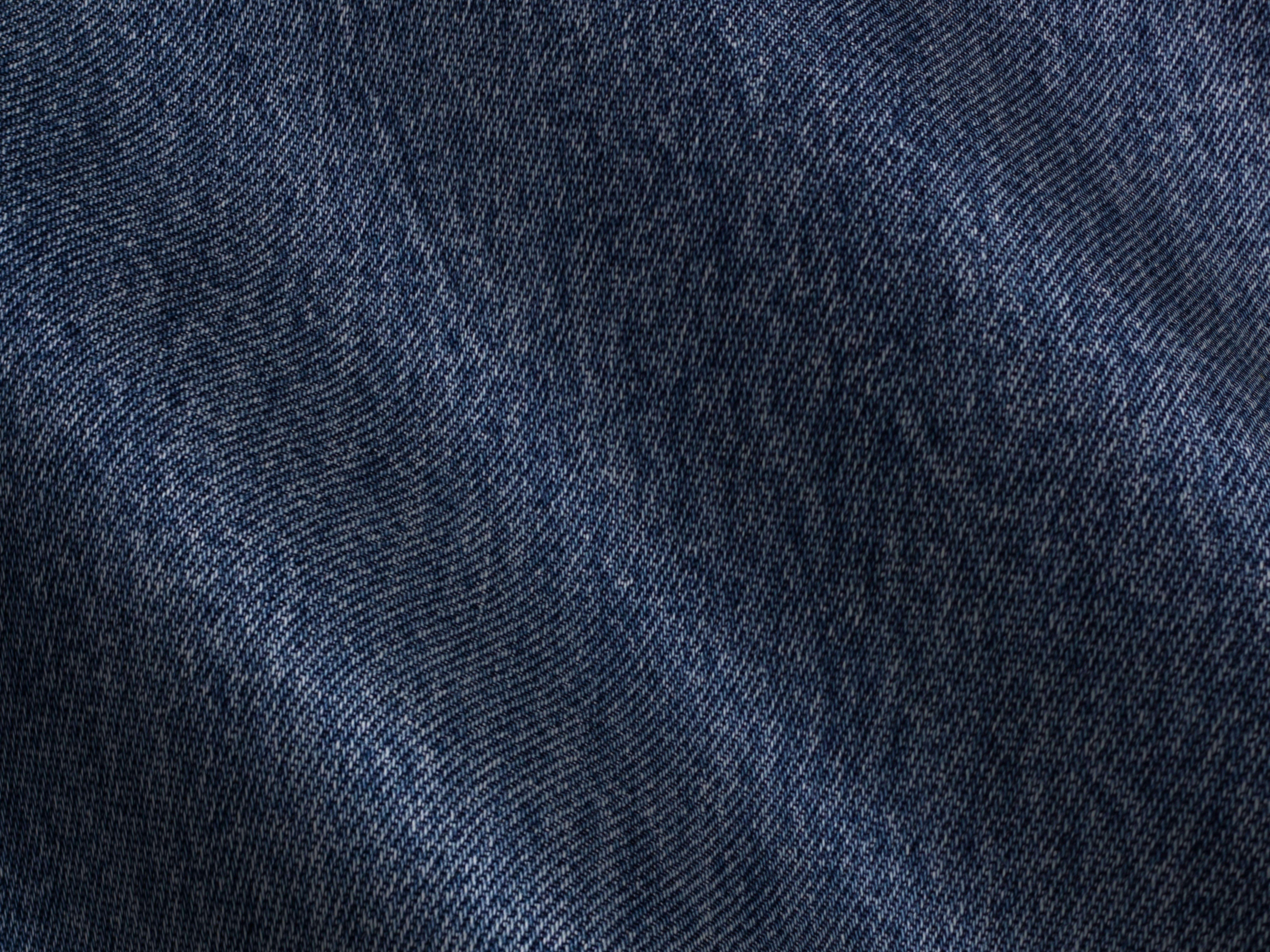 Free Detailed close-up view of blue denim fabric showcasing texture and pattern. Stock Photo