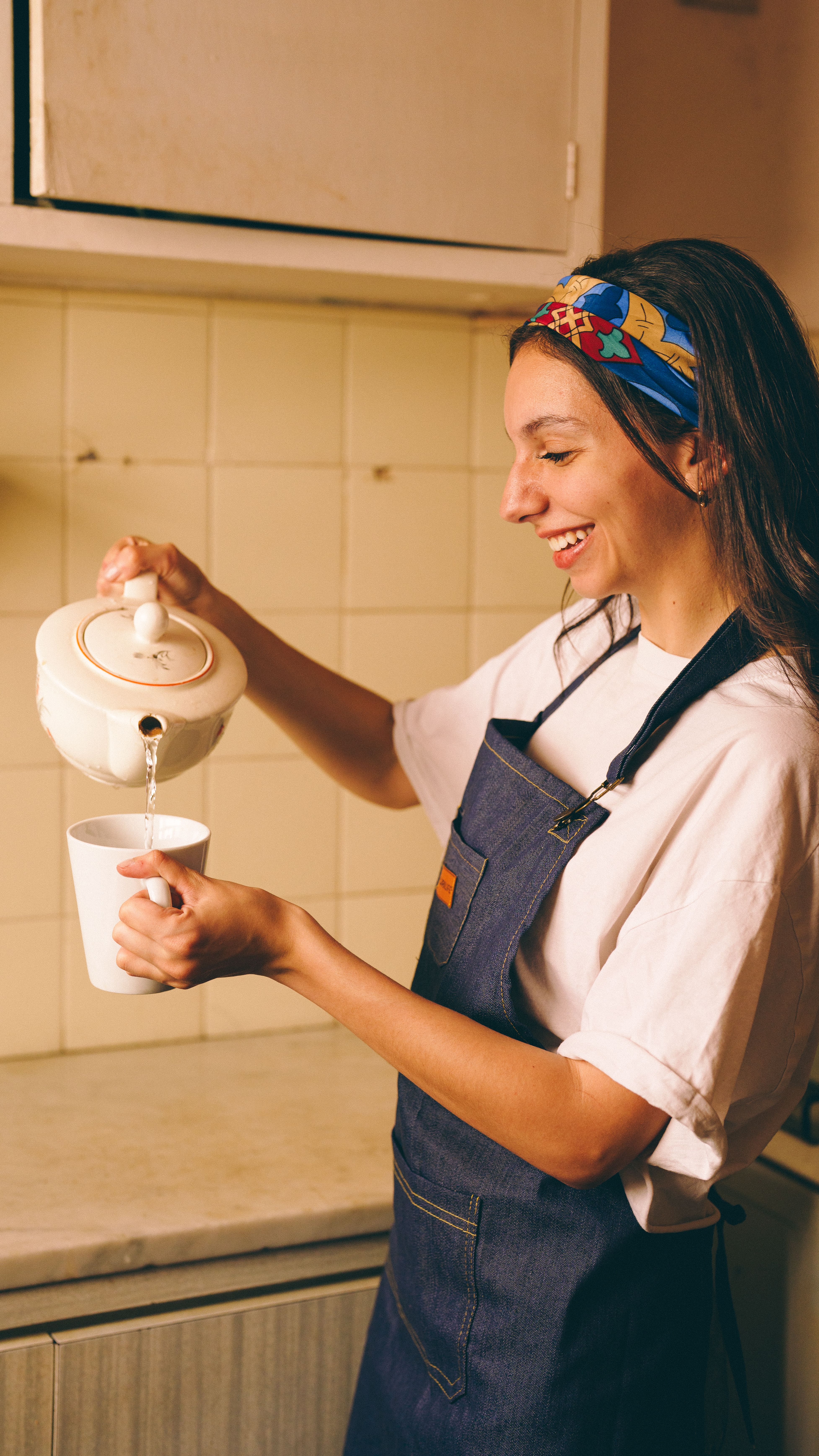 Founder pouring tea behind the counter