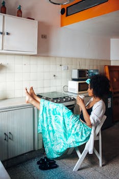 Woman enjoying a tranquil morning with coffee in a cozy kitchen setting.