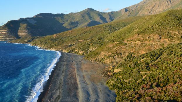 A breathtaking aerial view of Nonza Beach along the rugged coastline of Corsica, France.