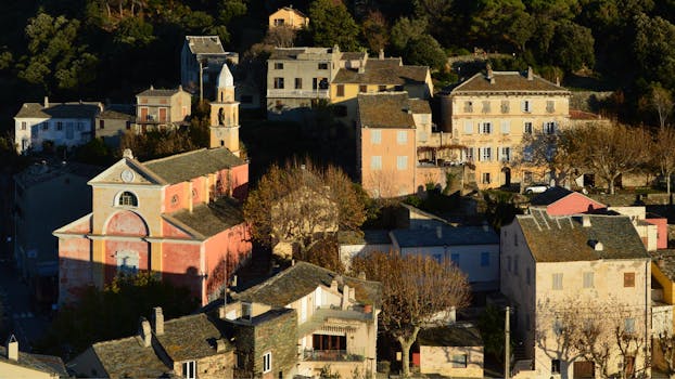 Picturesque view of a traditional Corse village at sunset, showcasing historic architecture.