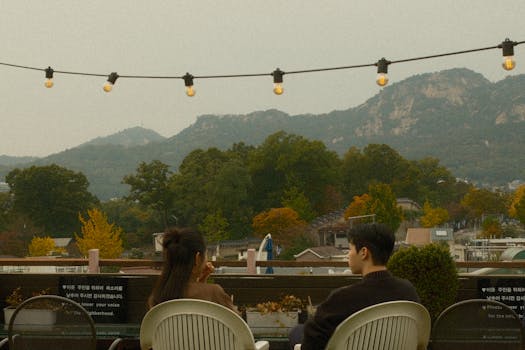 Relaxing on a rooftop with scenic views of Seoul's natural beauty. A perfect urban escape.