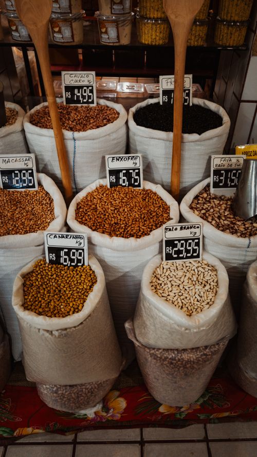 Free Diverse selection of grains and legumes in sacks at a market with price tags in view. Stock Photo