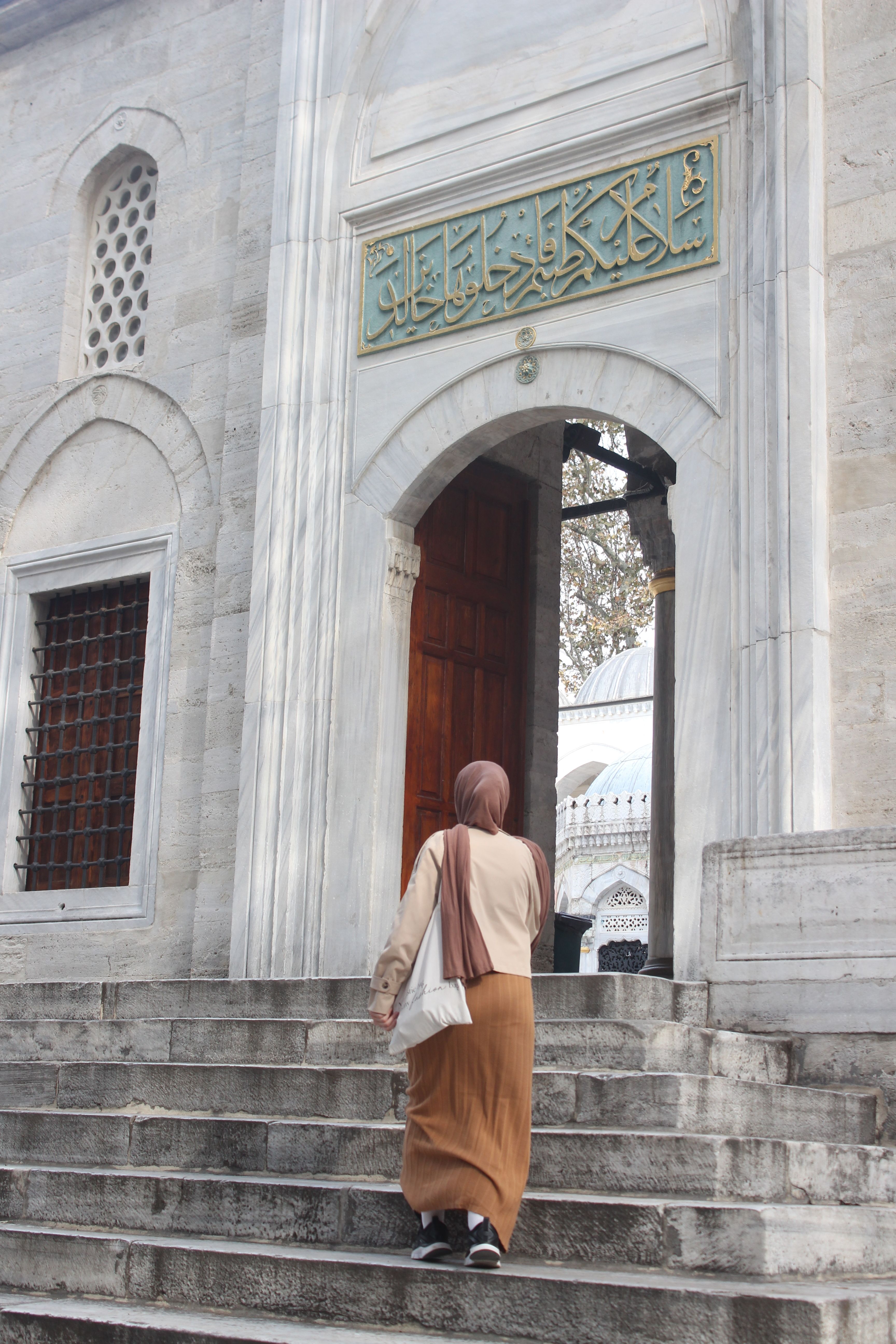 Woman Walking into Historic Mosque Entrance · Free Stock Photo
