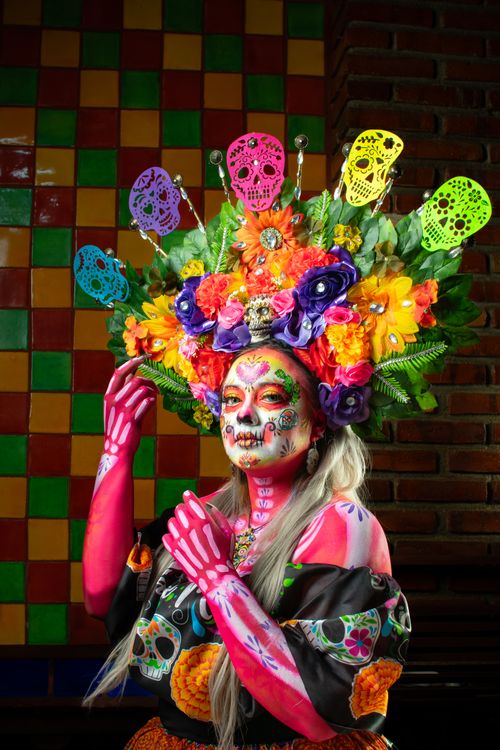 Free Colorful Day of the Dead costume with floral headdress and skeleton makeup. Stock Photo
