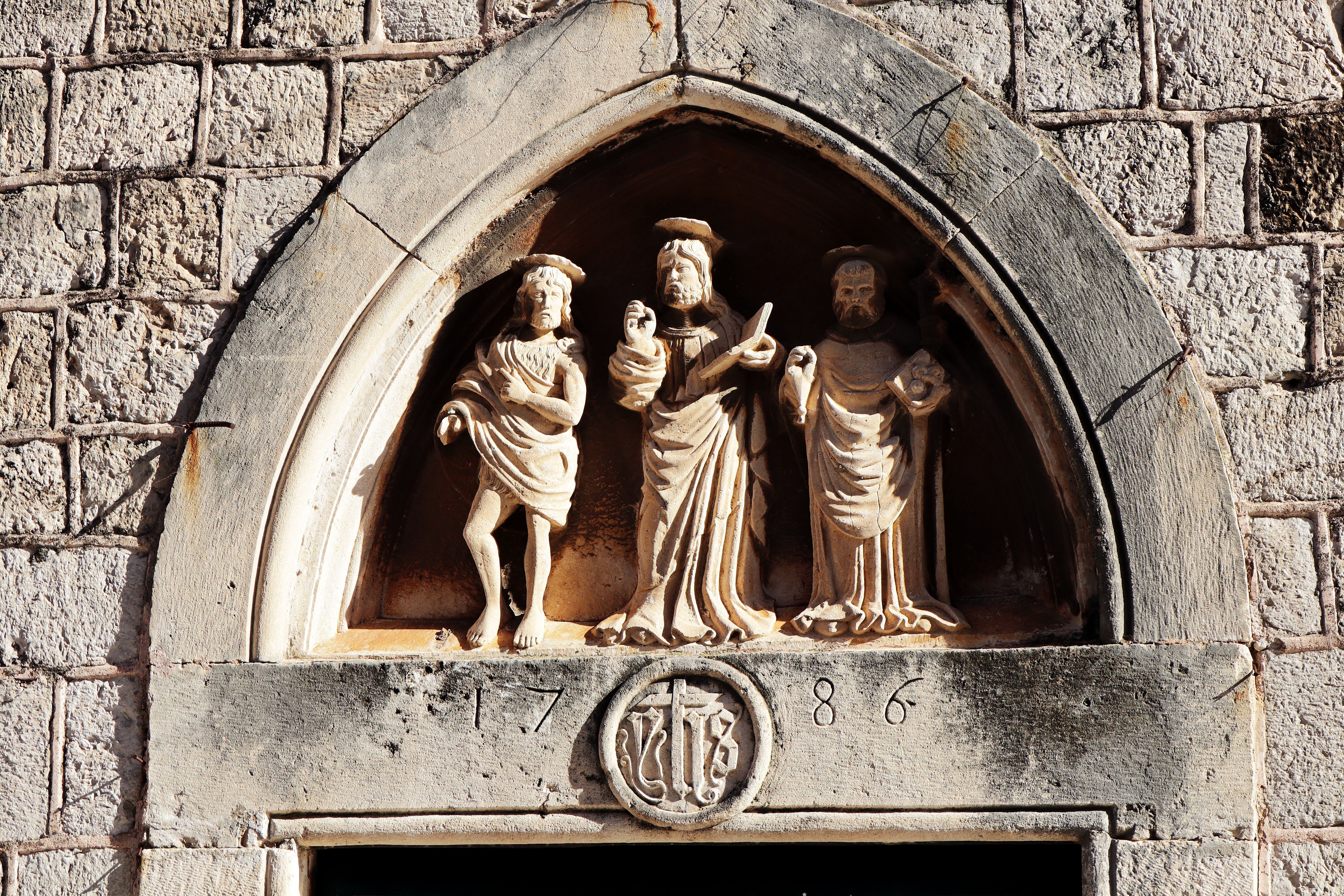 Palm and olive branches at a Dubrovnik church entrance during Holy Week