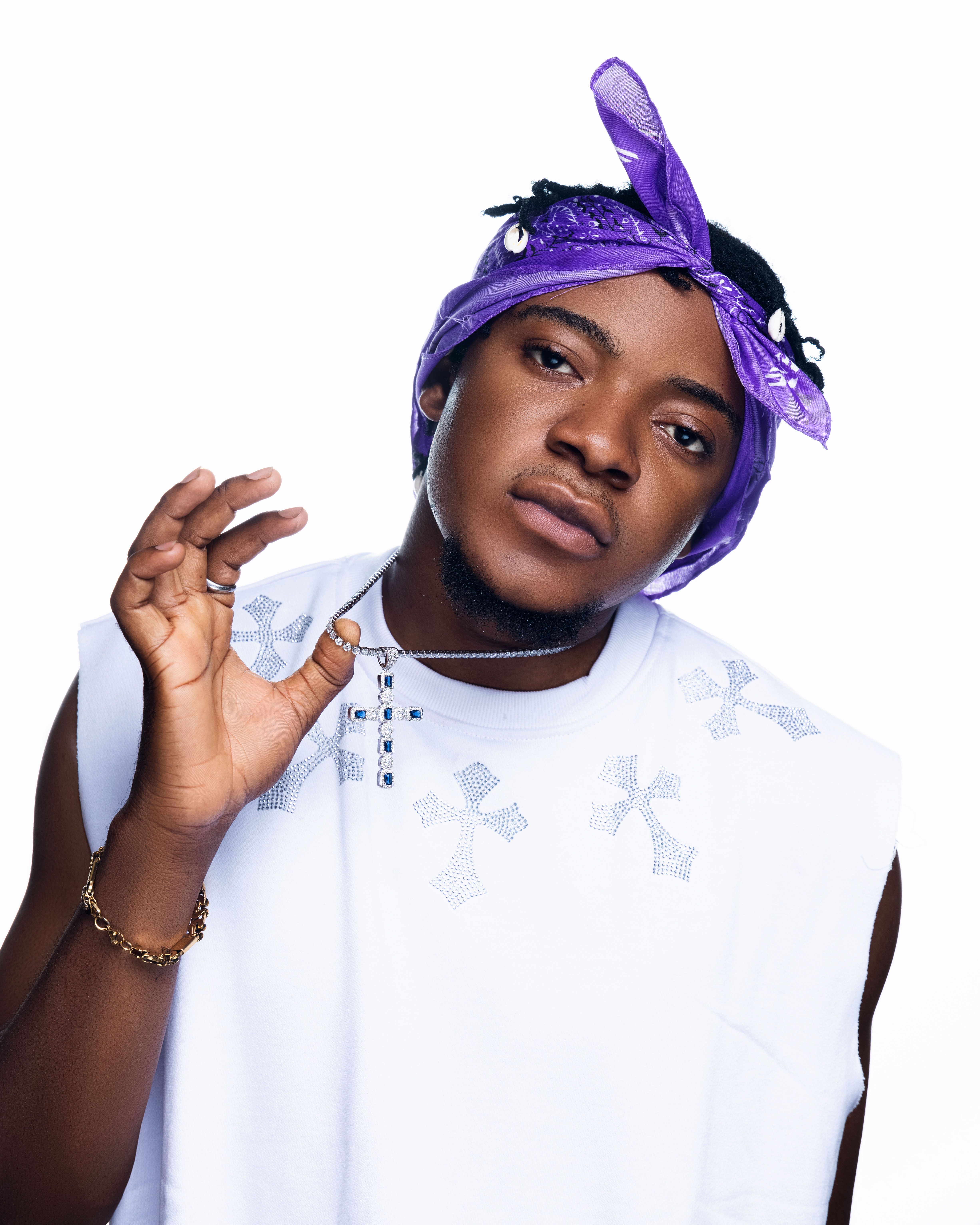 Stylish portrait of a young black man wearing a purple bandana and jewelry, showcasing urban fashion.