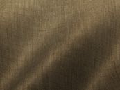 Close-up of textured brown linen fabric showing detailed weave and natural folds.