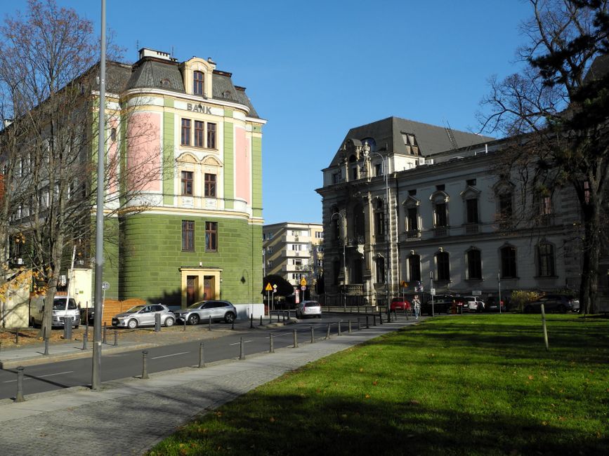 View of historic European buildings with colorful facades and clear blue sky.