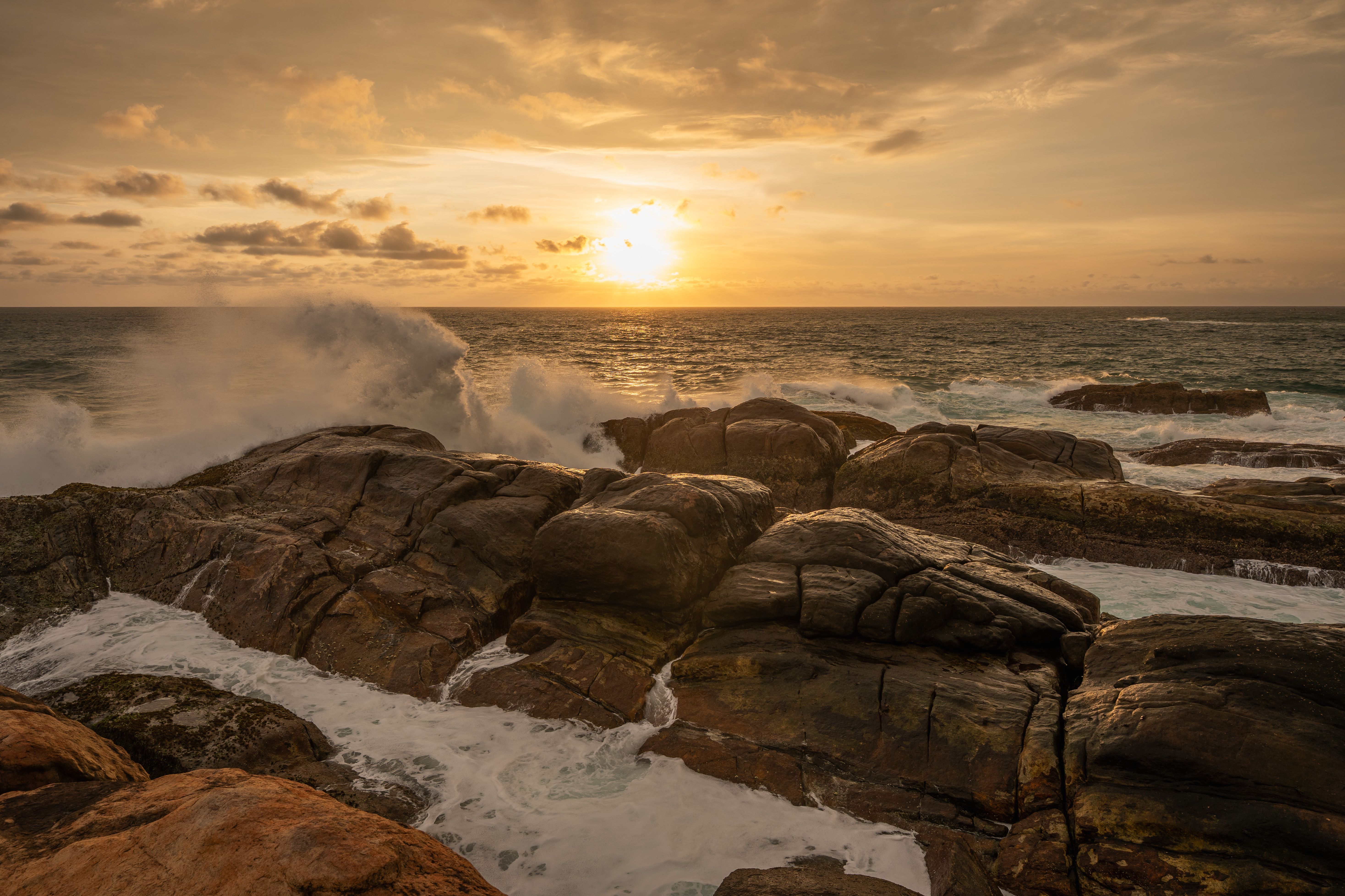 Dramatic Sunset Over Rocky Ocean Shore · Free Stock Photo