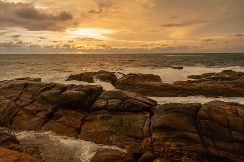 Free Beautiful rocky coastline at sunset with ocean waves crashing in Sri Lanka. Stock Photo