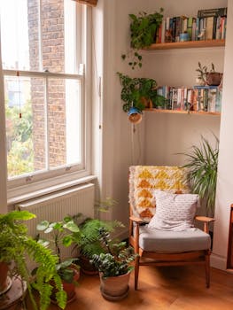 Bright, cozy reading corner with armchair and plants, perfect for relaxation.