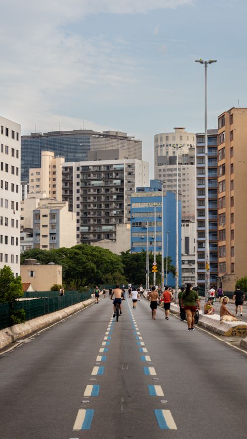 Free A vibrant street scene in São Paulo, Brazil, with bikers and pedestrians against a backdrop of modern architecture. Stock Photo