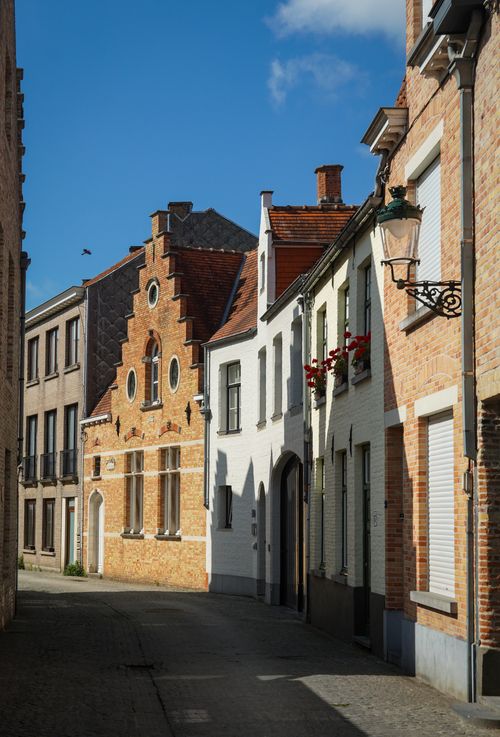 Free Picturesque street in Brugge, showcasing classic Flemish architecture on a sunny day. Stock Photo