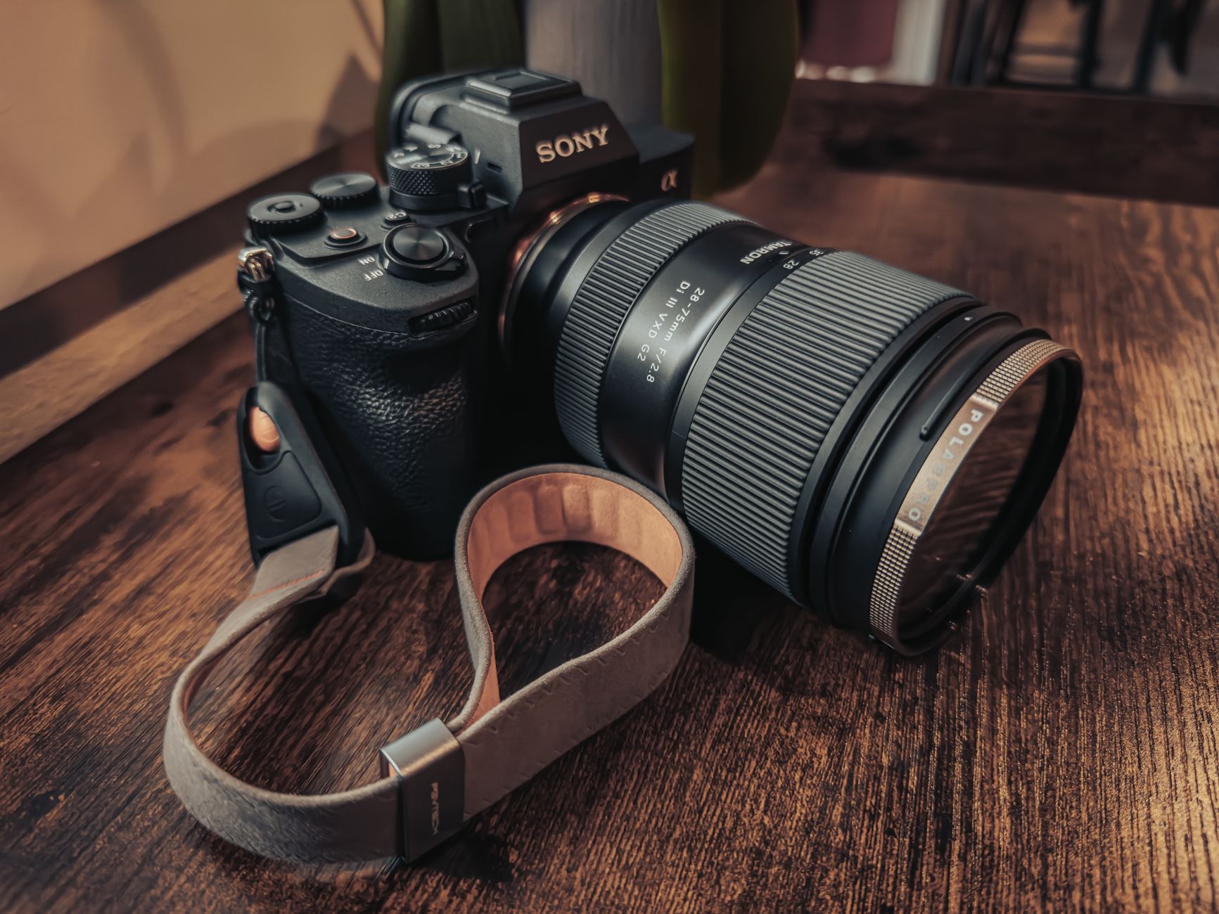 Detailed close-up of a professional camera with a lens on a wooden table