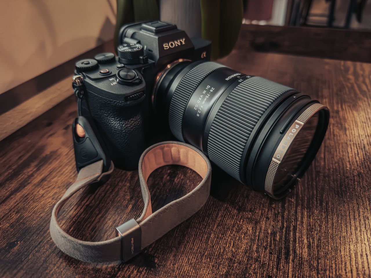 detailed close up of a professional camera with a lens on a wooden tab