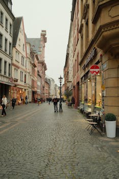 Charming street in Mainz, Germany, showcasing historic timber-framed buildings and cobblestones.