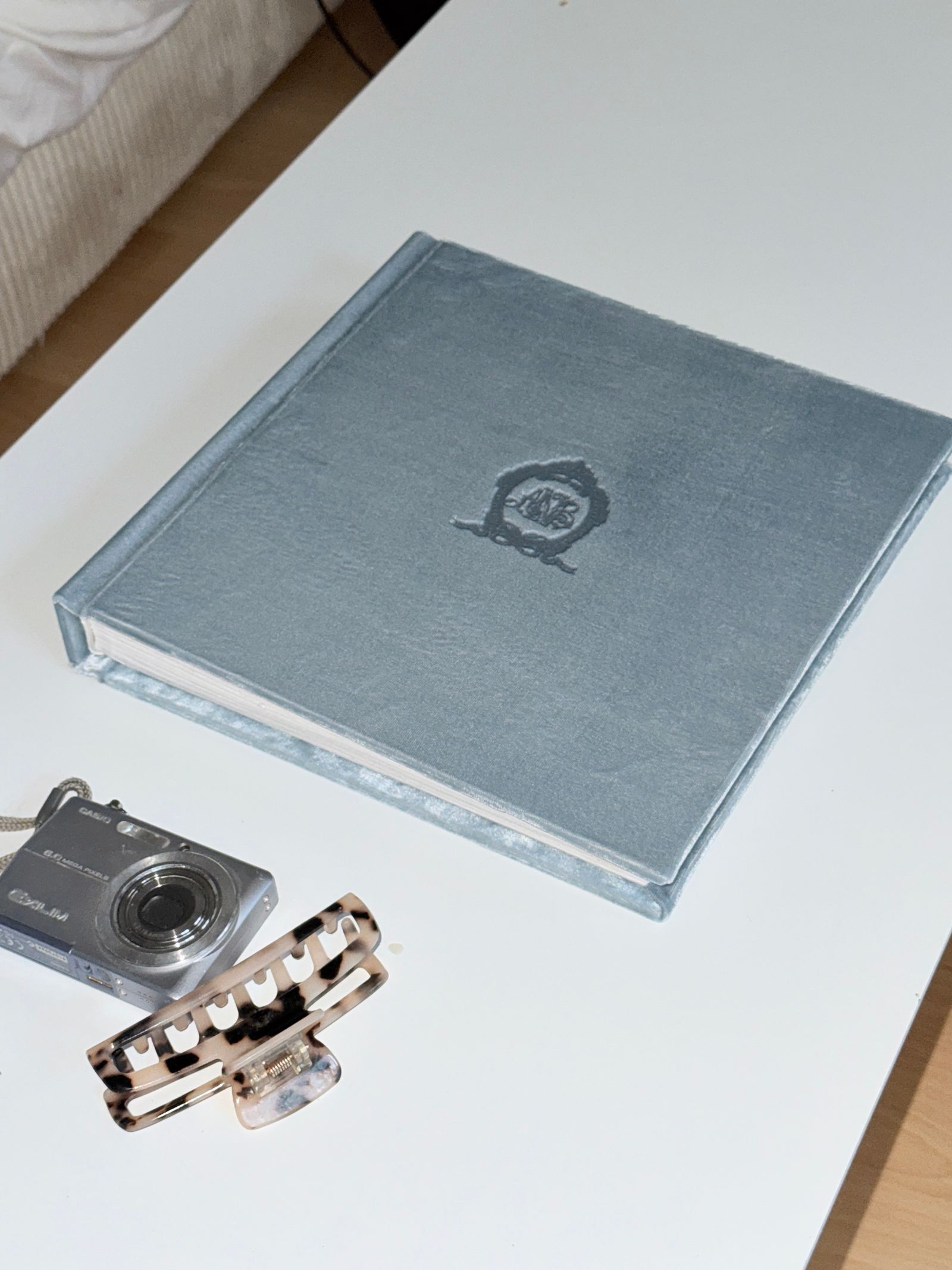 Printed photographs and an album spread across a table.