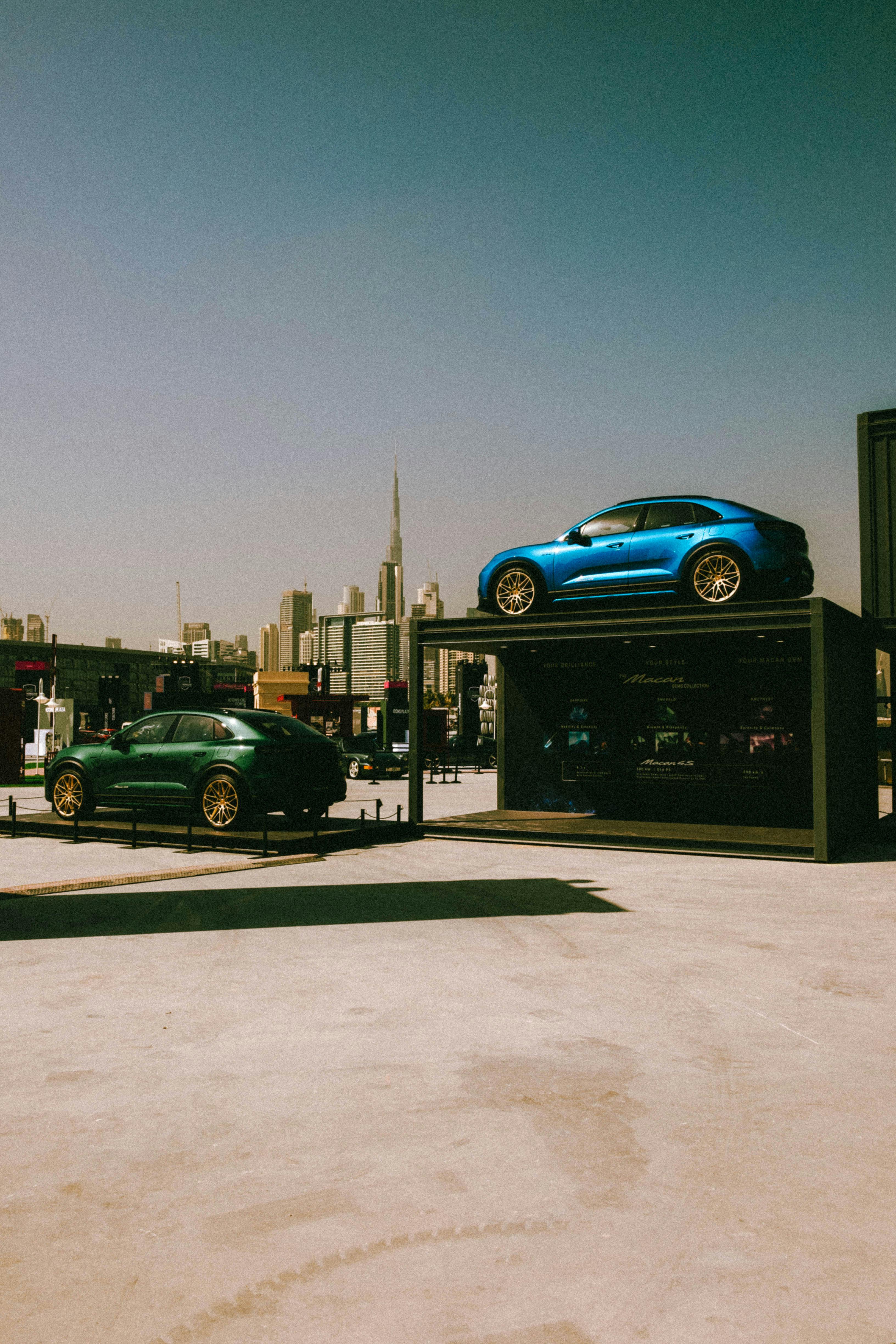 Free A stunning display of blue and green luxury sports cars against the iconic Dubai skyline. Stock Photo