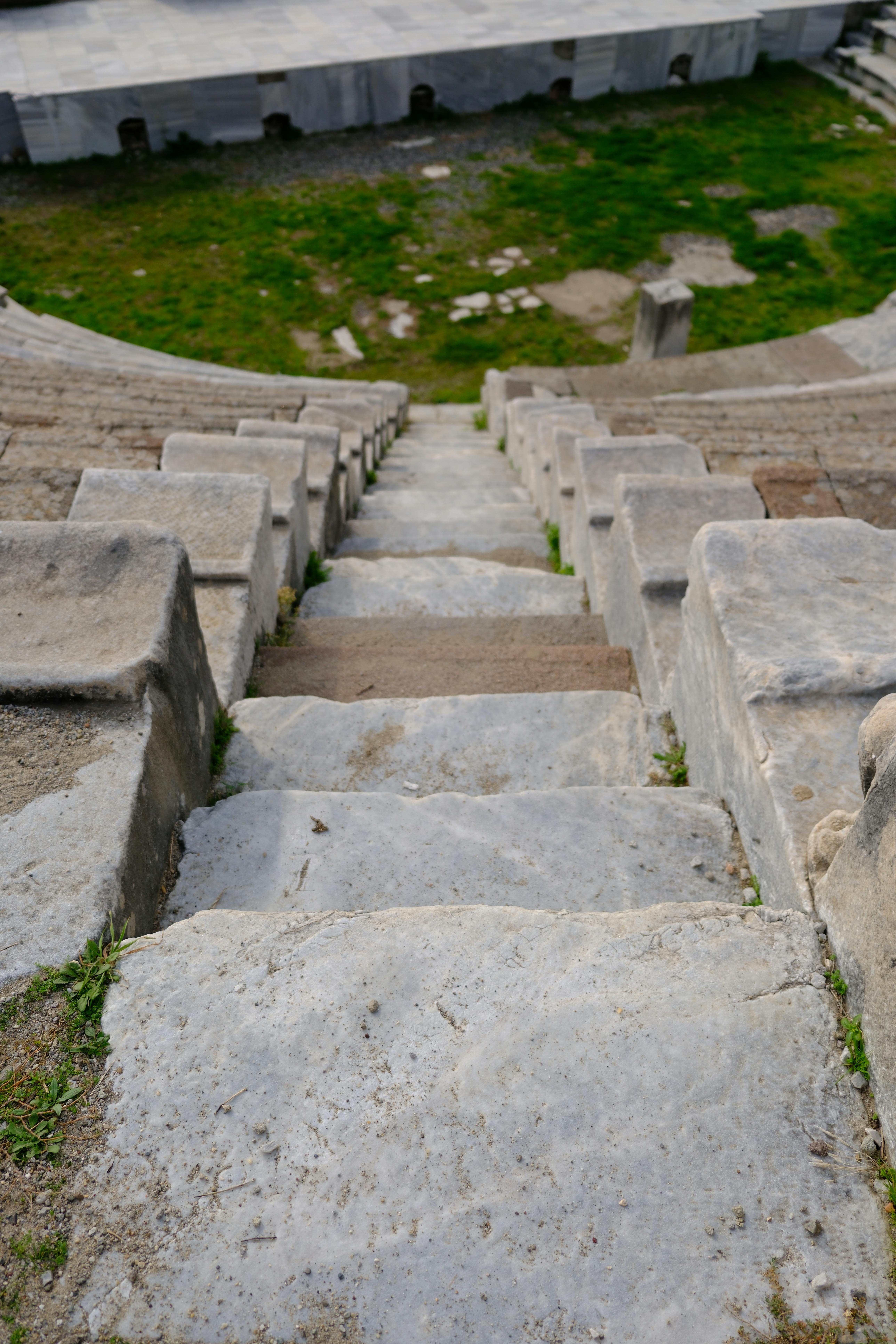 Free View of ancient stone steps descending into the Roman theater in Bergama, İzmir, Türkiye. Stock Photo