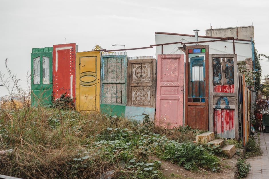 A vibrant collection of doors forming an artistic installation in an urban environment.