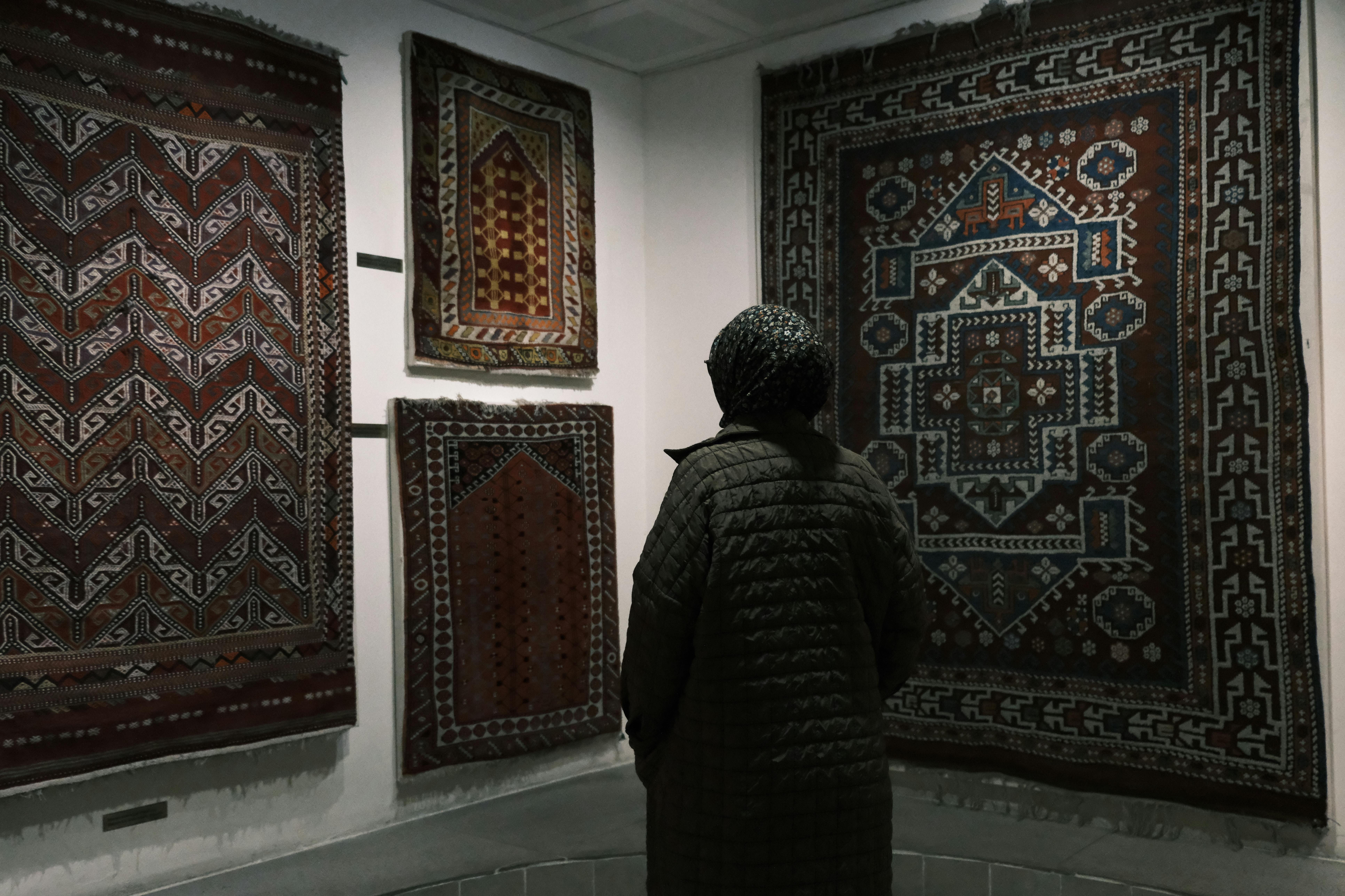 A woman admires traditional Turkish kilims at a museum in Bergama, İzmir.