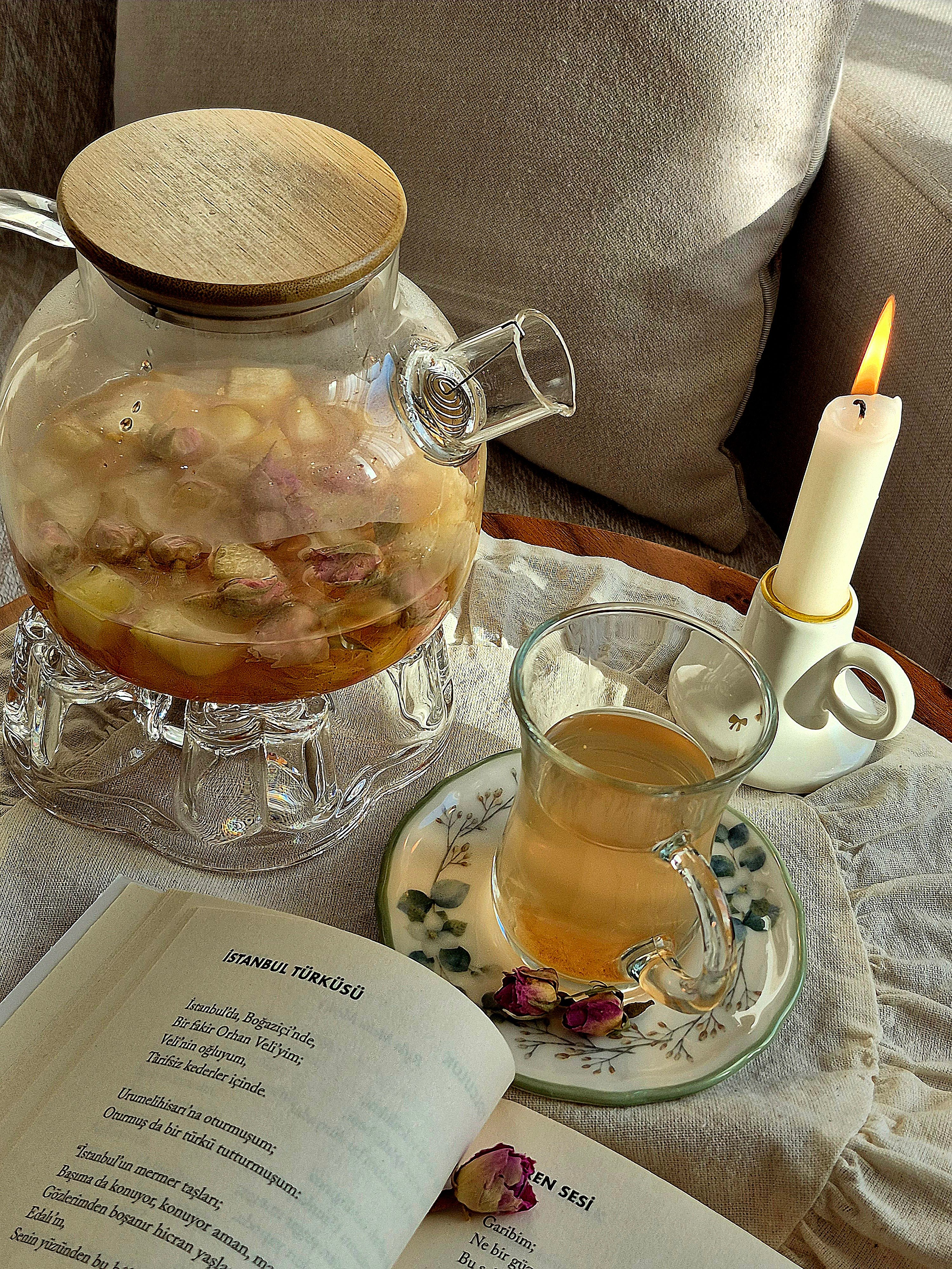 Cozy Tea Setting with Candlelight and Poetry · Free Stock Photo