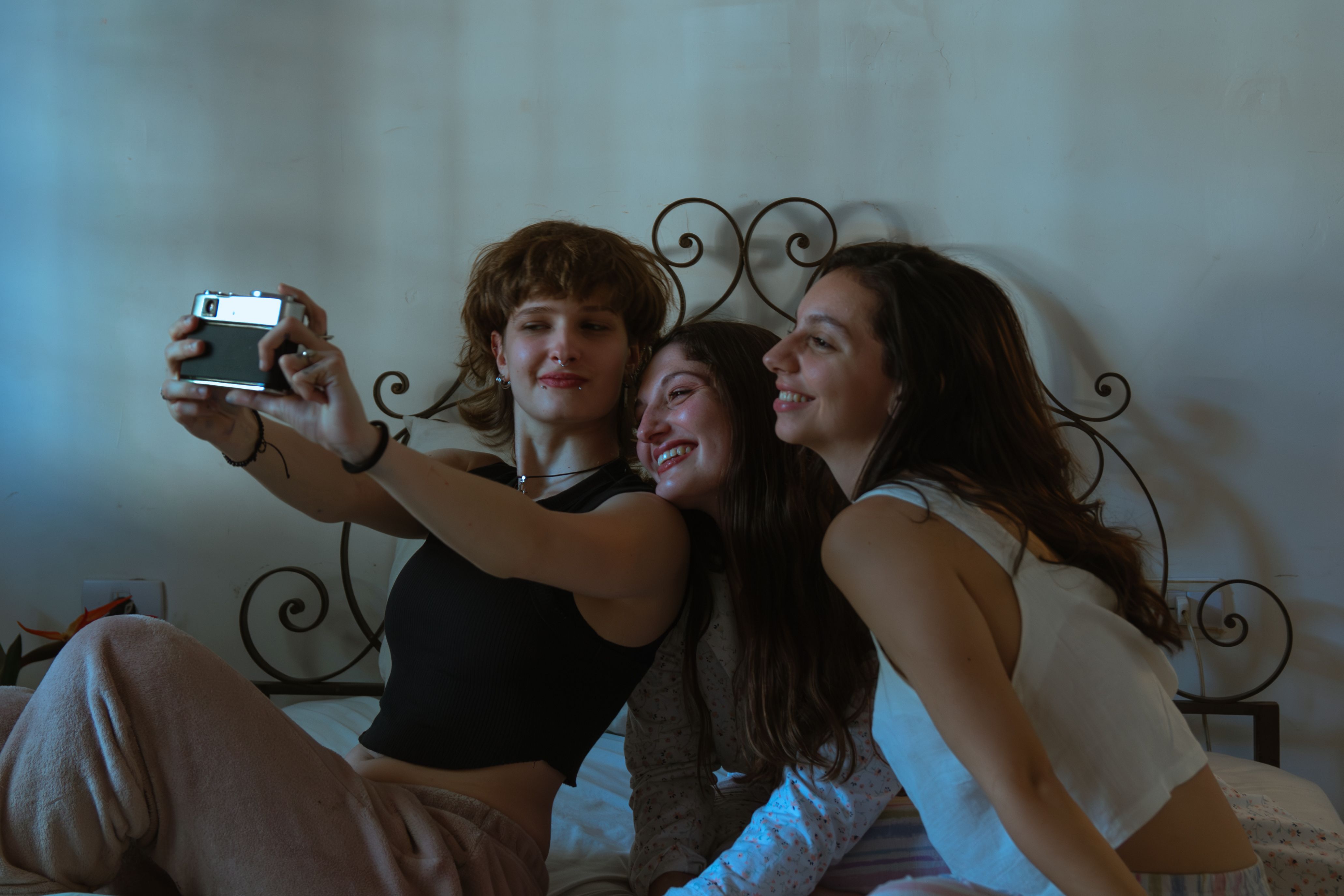 Trio of Friends Taking a Selfie on Bed · Free Stock Photo