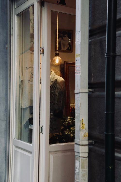 Free Stylish boutique window showcasing vintage clothing and elegant decor. Stock Photo