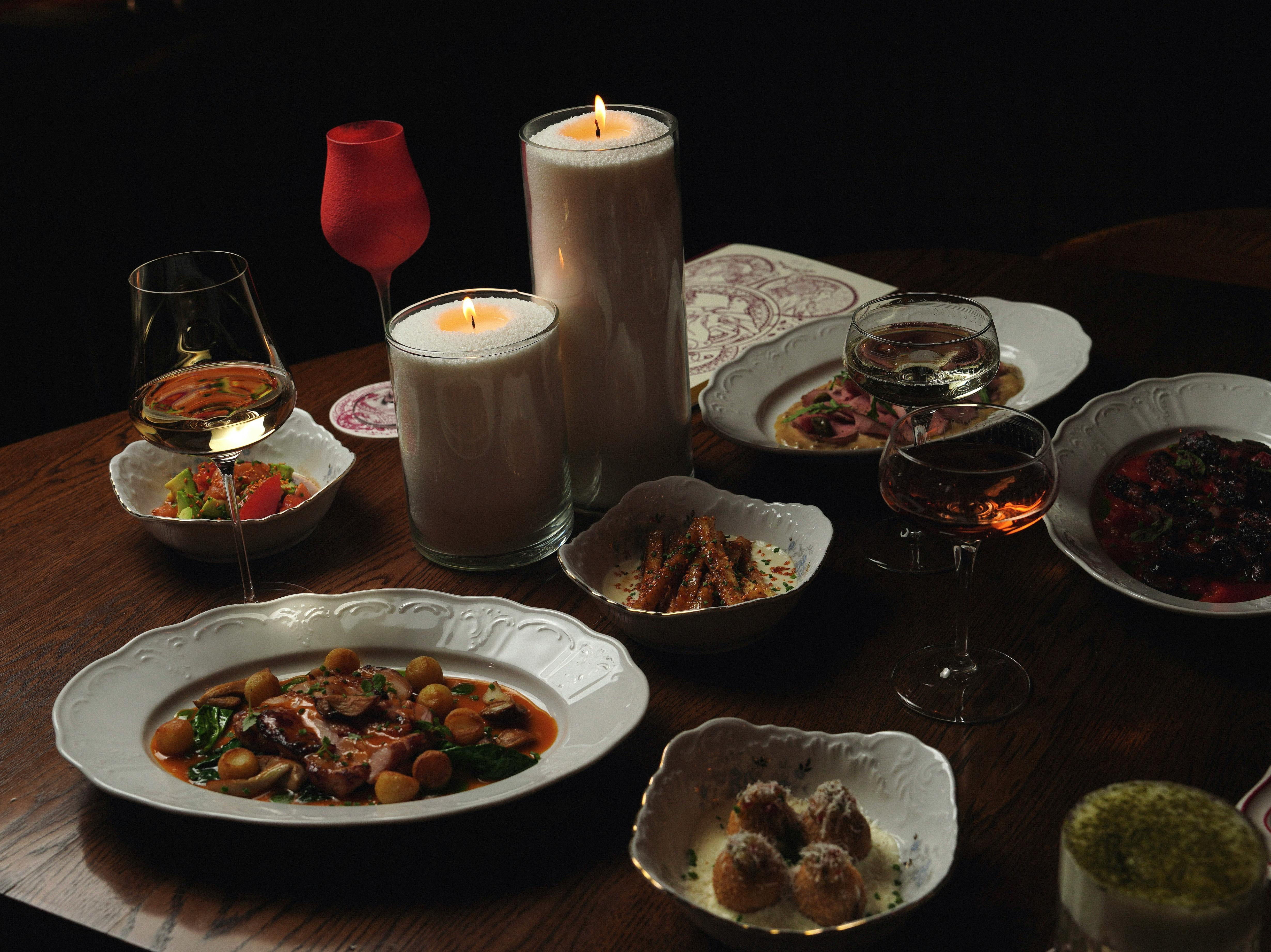 A luxurious dining table setup with gourmet dishes and candlelight mood.