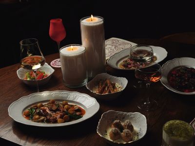 Table spread of small plates by candlelight — photo by Nadin Sh on Pexels