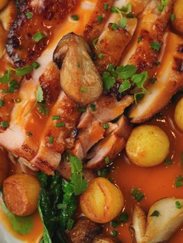 Delicious roasted chicken with vegetables, mushrooms, and savory sauce.