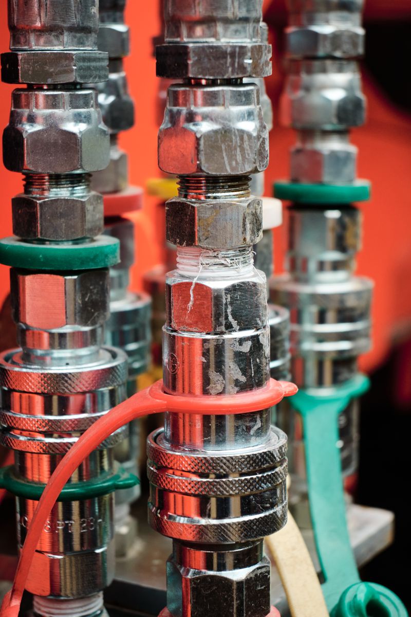 Detailed view of color-coded metal fittings on a machine