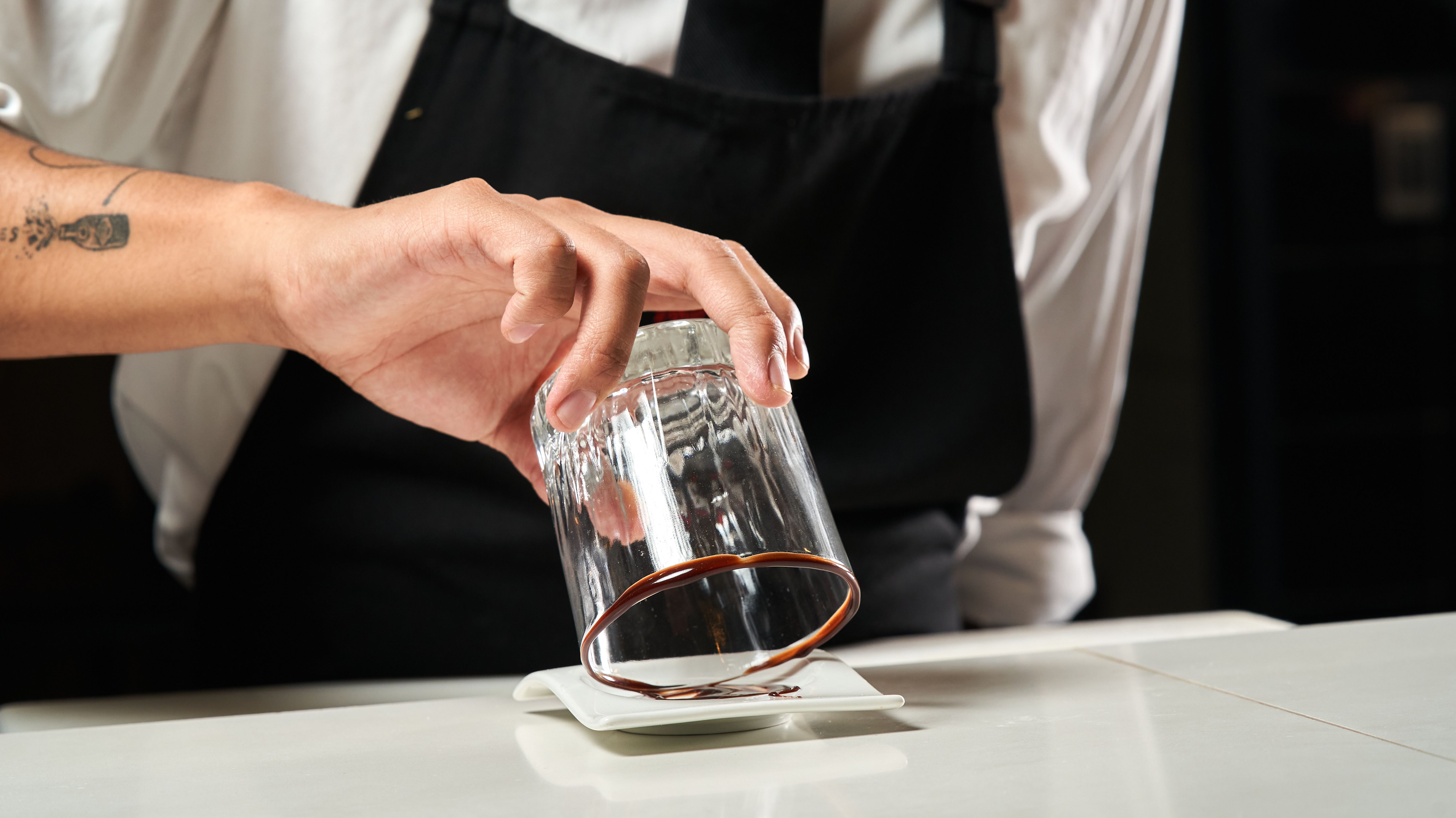 Bartender Mixing Drink with Glass and Syrup · Free Stock Photo