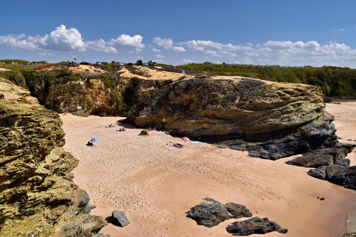 Free Idyllic rocky beach with clear skies in Setubal, Portugal. Perfect summer getaway. Stock Photo