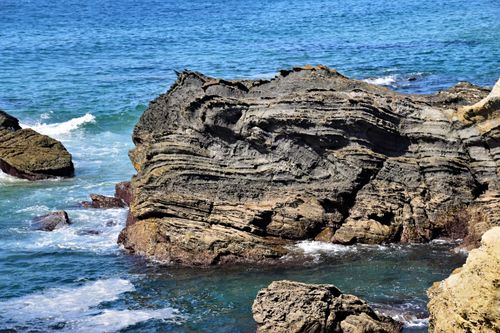Free Stunning coastal rock formations and clear blue waters in Setúbal, Portugal, captured in summer. Stock Photo