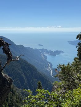 Breathtaking aerial view of the ocean meeting lush green mountains.