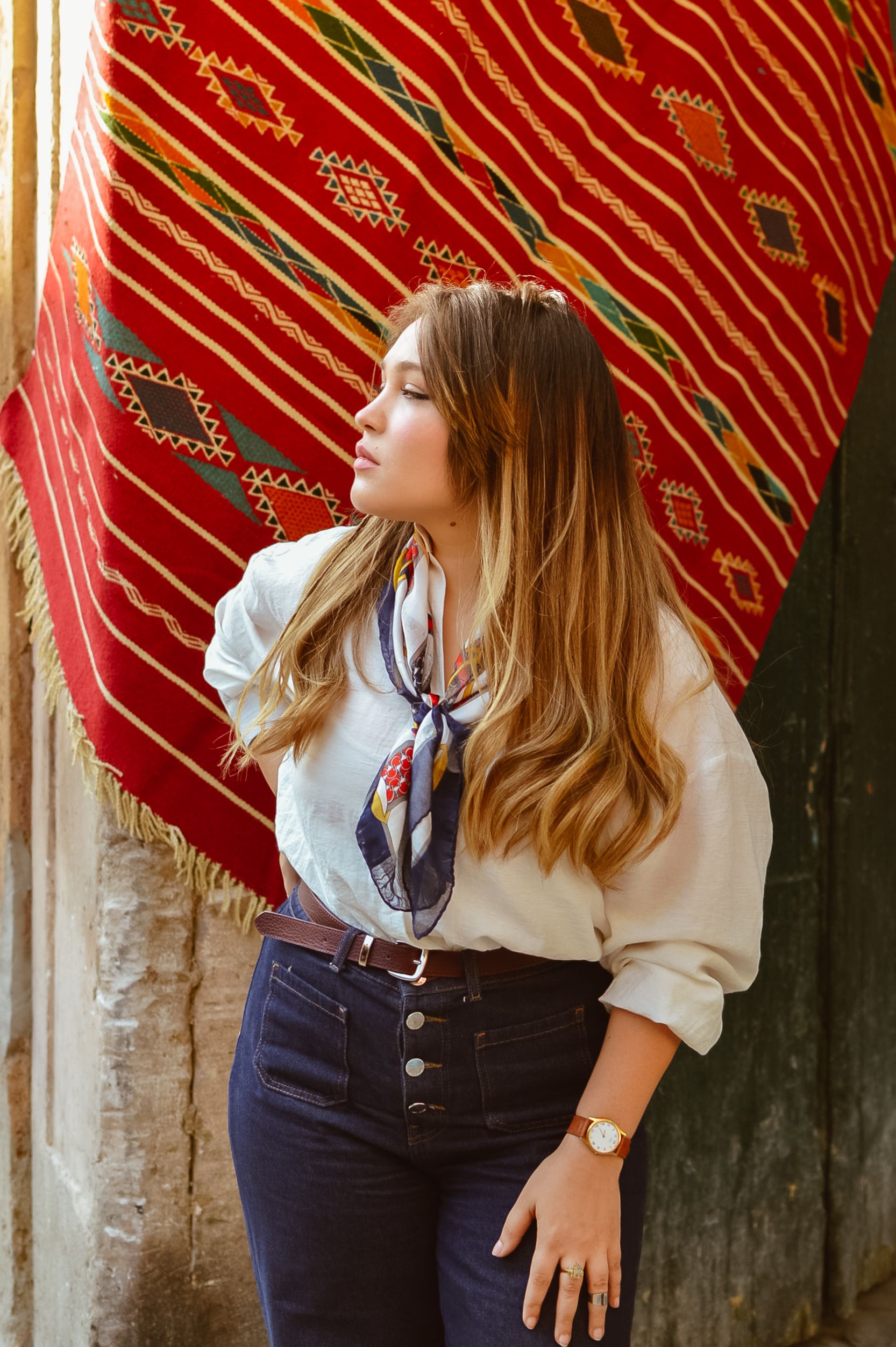 Stylish Woman Posing with Traditional Rug Backdrop · Free Stock Photo