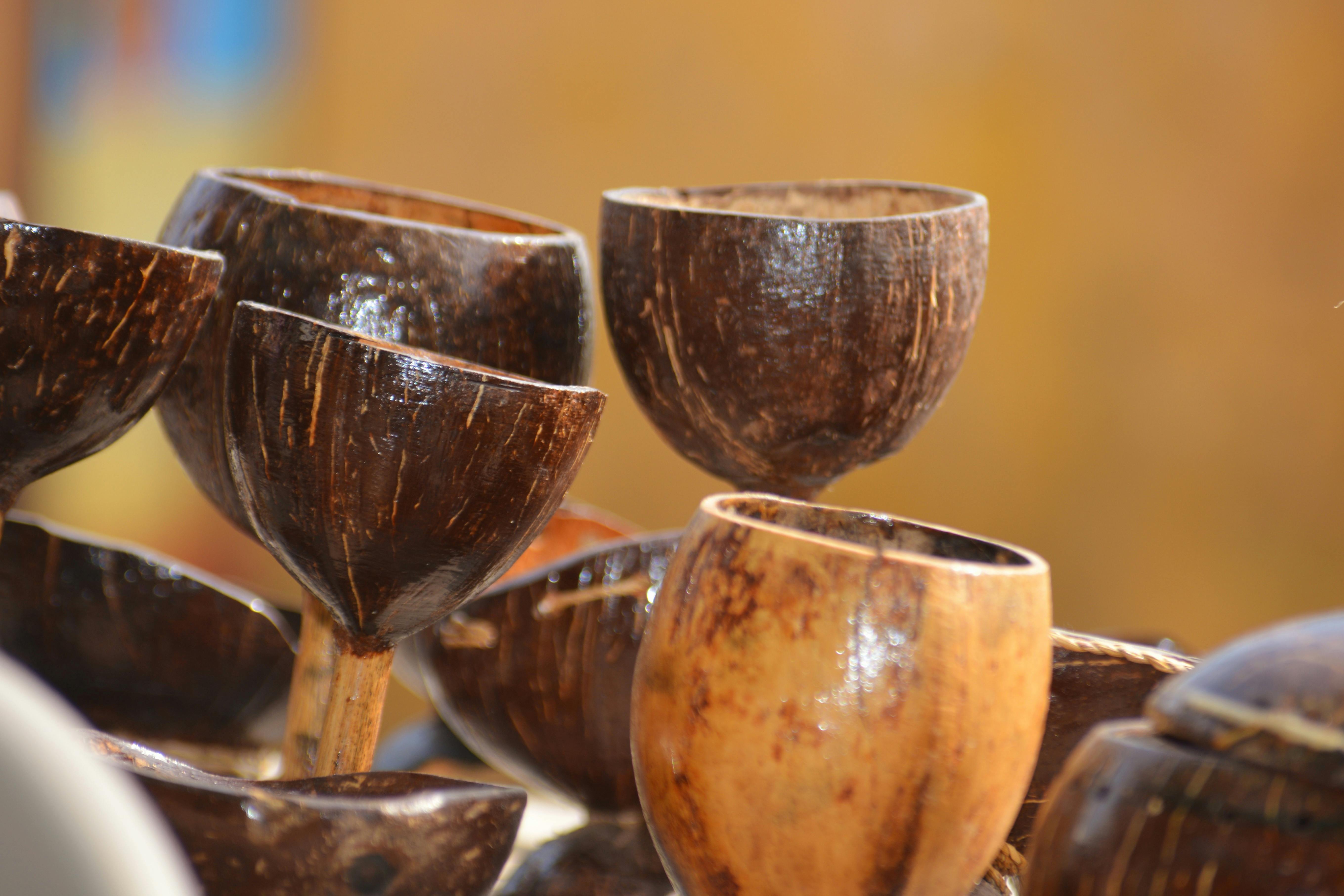 Handcrafted coconut shell bowls on display in a vibrant Hampi market.