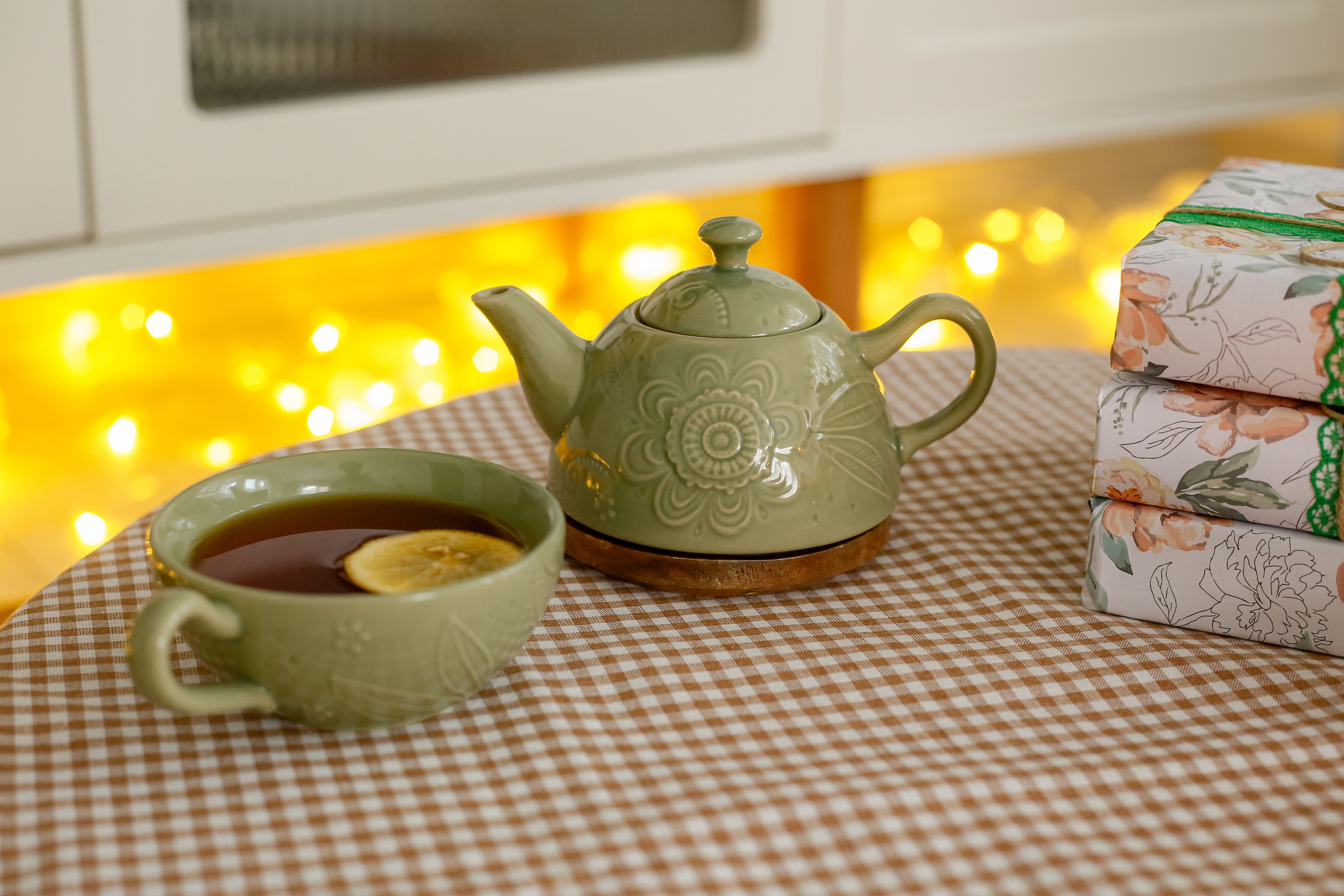A cozy living room with fairy lights, a book, and a cup of tea, representing intentional solitude
